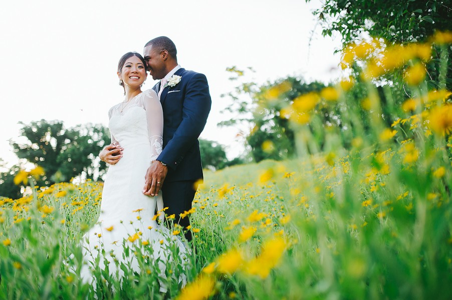 Wedding portraits in field of yellow flowers