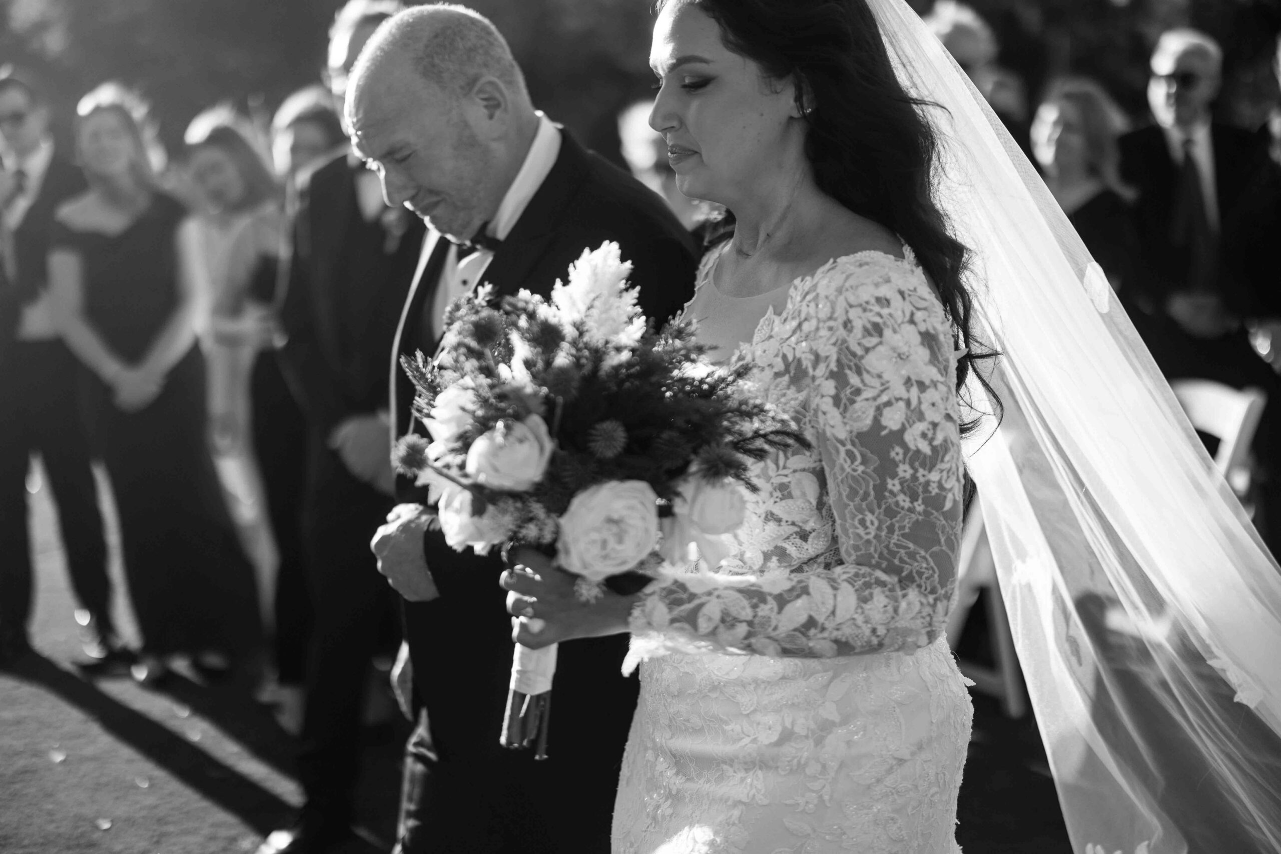 Bride walking down the aisle with her father during the wedding ceremony